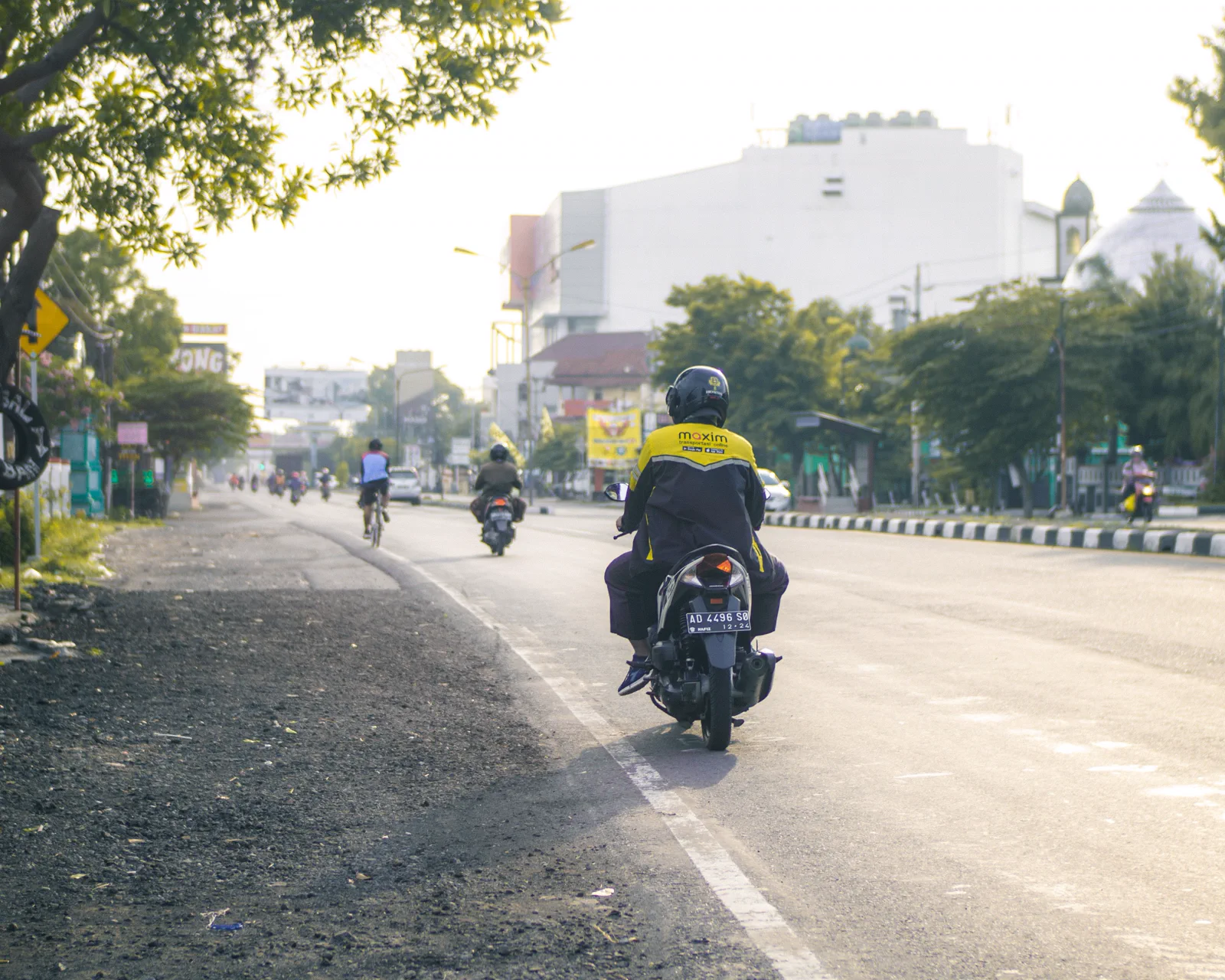 Entregador ao lado de uma moto urbana usada no trabalho